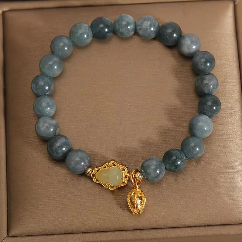 Sky blue natural stone gourd lotus flower pendant on a women's adjustable bracelet with electroplated metal.
