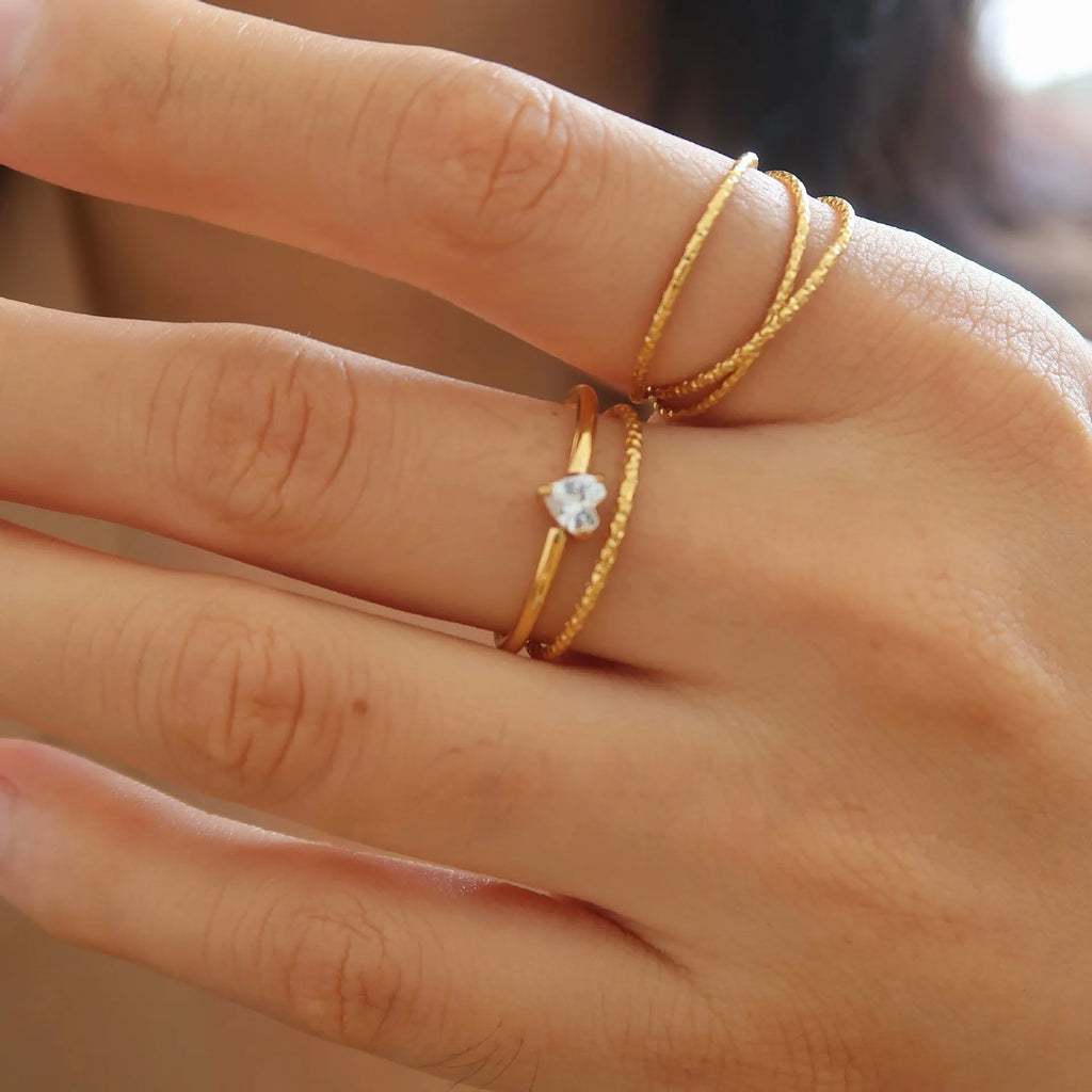 Golden electroplated stainless steel heart ring with oval design elements in women's sizes 5-8