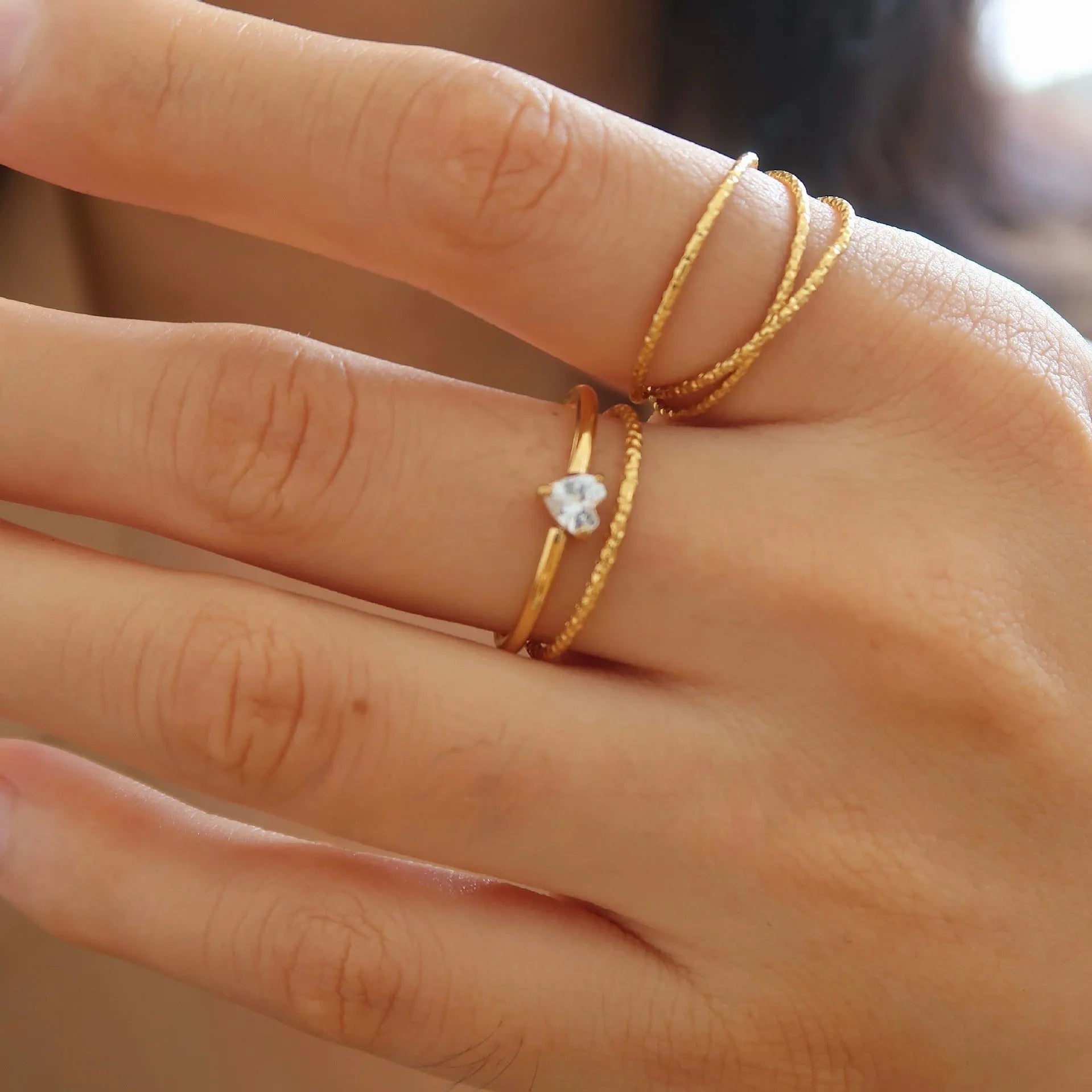 Golden electroplated stainless steel heart ring with oval design elements in women's sizes 5-8