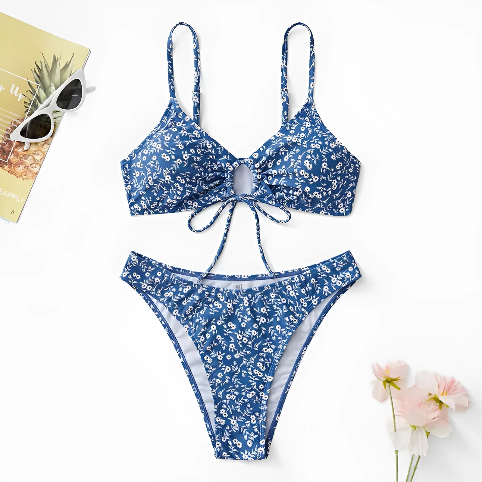 Blue women's three-piece swimsuit set with sleeveless top and shorts on a white background.