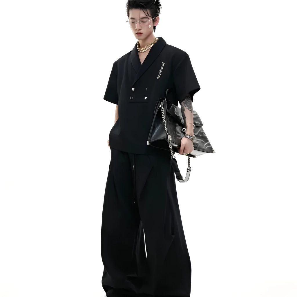 Men's dark grey V-neck short sleeve cotton sports jacket with padded shoulders and metal details, paired with matching shorts.