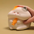 Small greedy cat cartoon desktop night light with yellow fin tuna design on a desk.