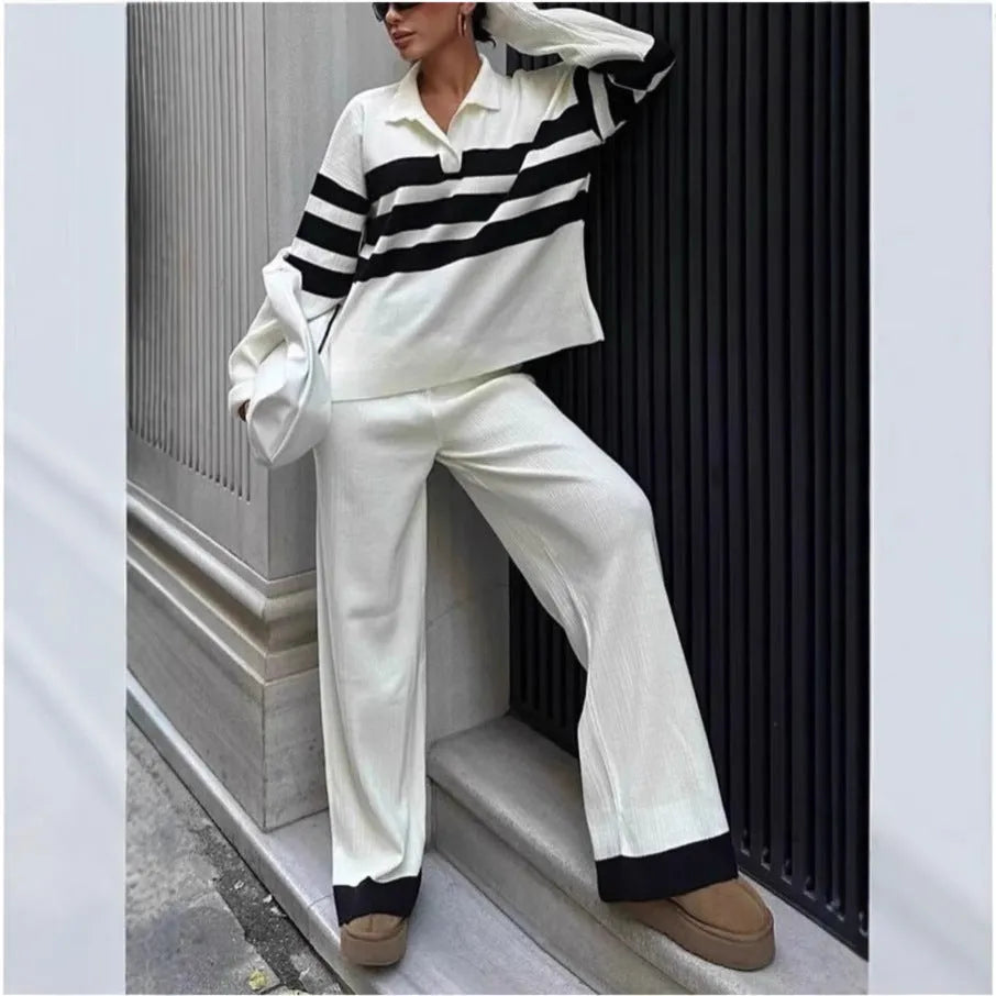 Women's black and white striped knitted polo collar two-piece set with long sleeves and trousers.