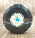 Black automatic robot vacuum cleaner on a wooden floor