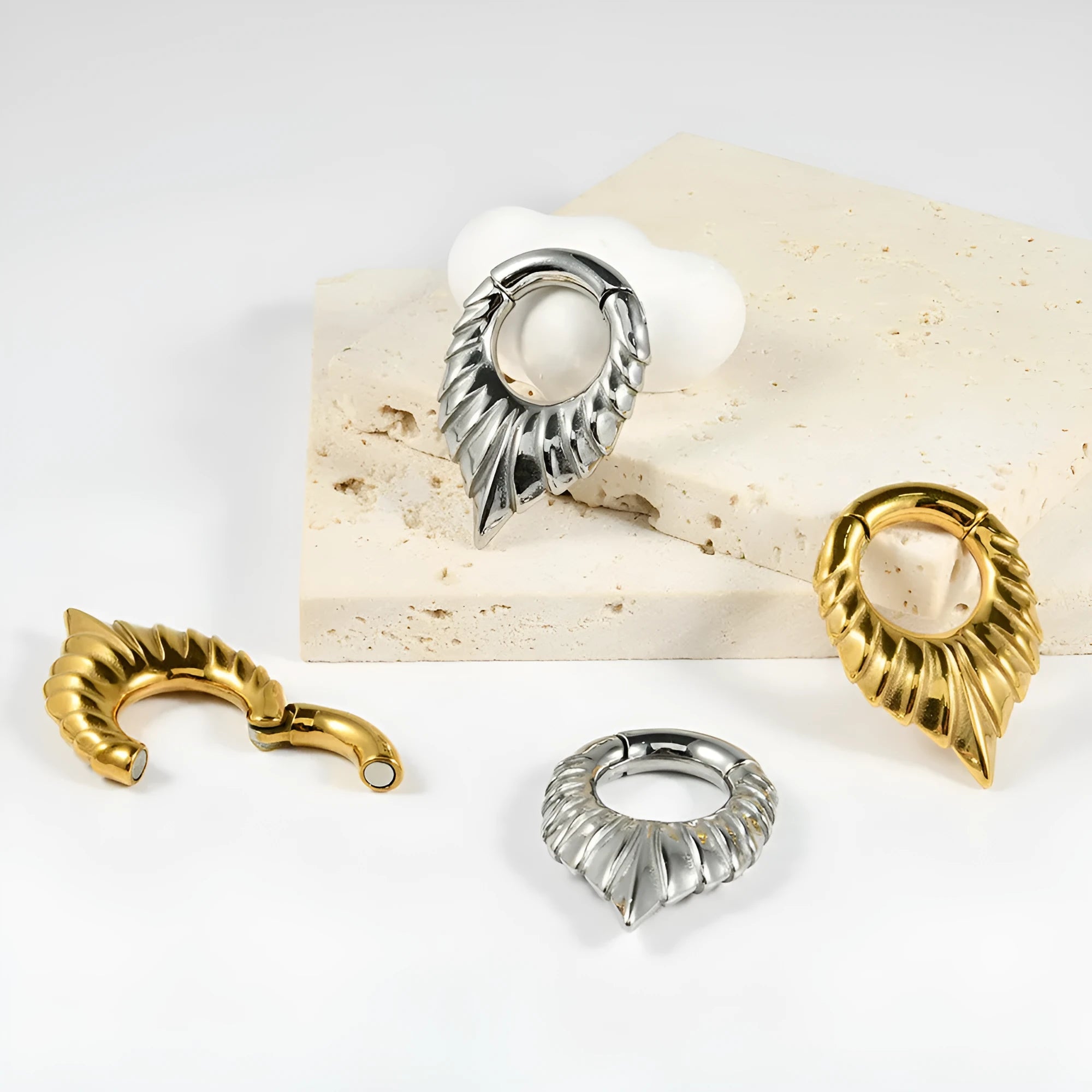 Stainless steel drop-shaped auricle ear extender with totem design on a round hanging egg form.