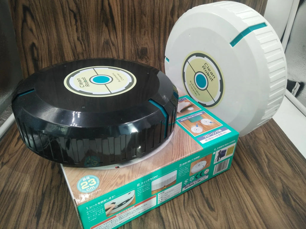 Black automatic robot vacuum cleaner on a wooden floor