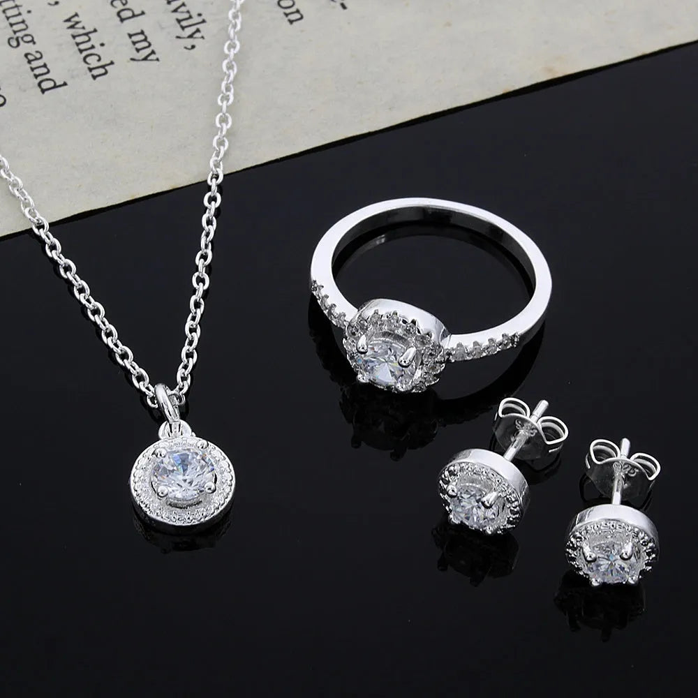 Zircon jewellery suit with inlaid apple ring and necklace silver tone on white background