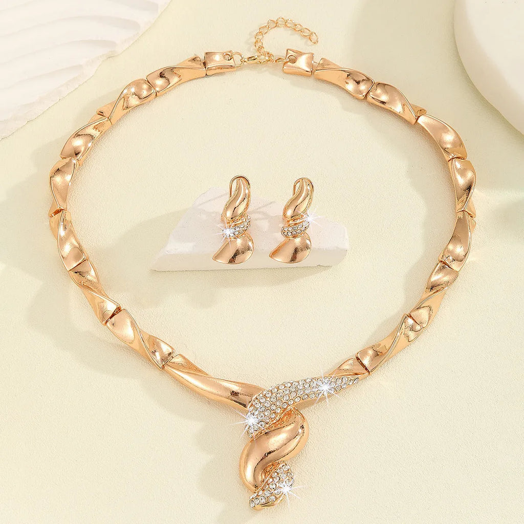 Gold alloy thread necklace and earrings suite with love heart pattern on a white background