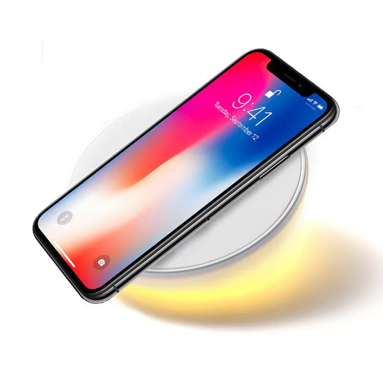 White wireless charger with clock display and three control buttons for smartphone charging