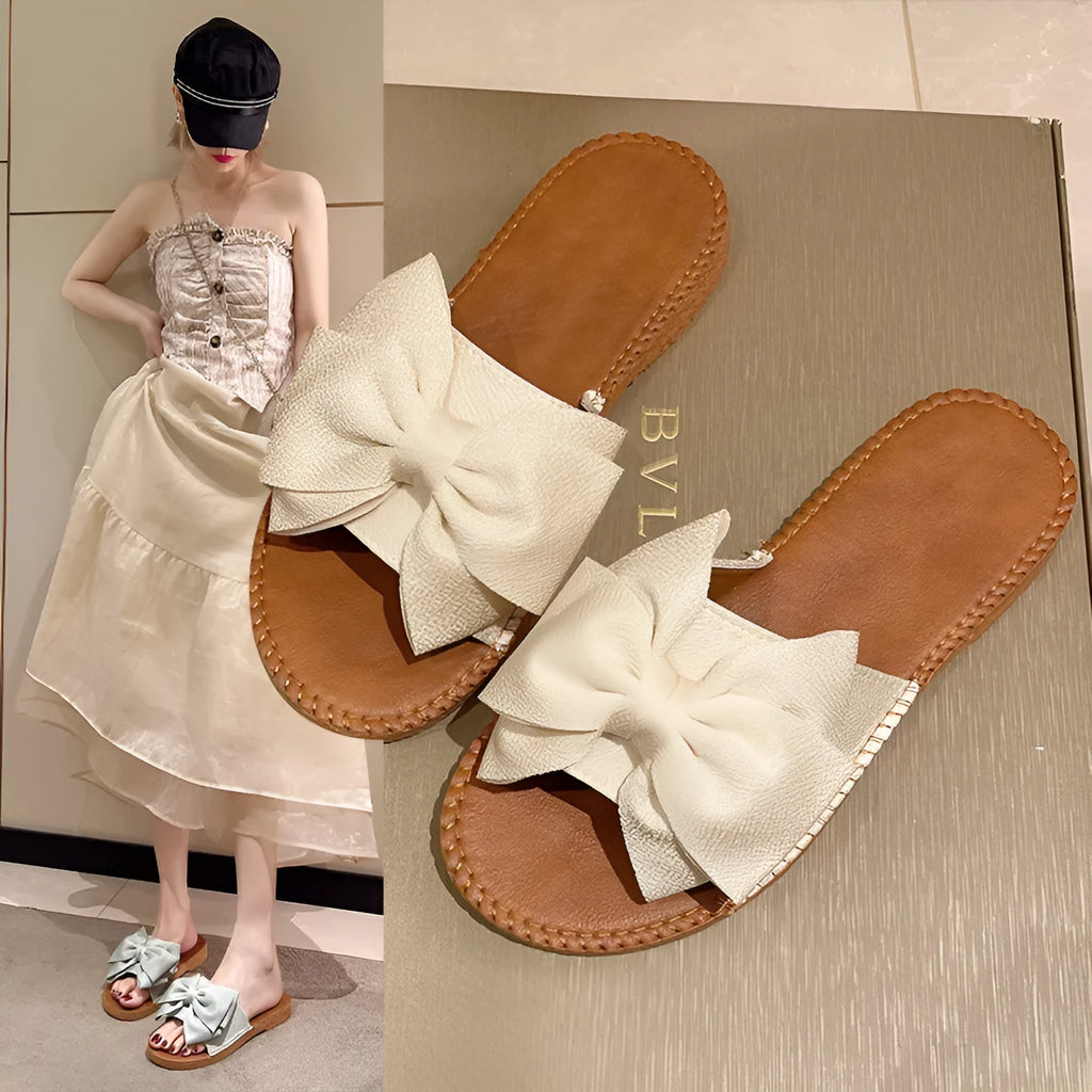 Women's slip-on cloth sandals with bow detail in beige, light green, and pink colours