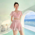 White two-piece women's swimsuit with a skirt bottom, shown alongside black and pink colour options.