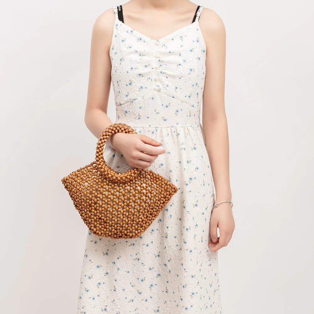 Hand-woven maple wooden bead beach bag in dumpling shape with hollow weave design