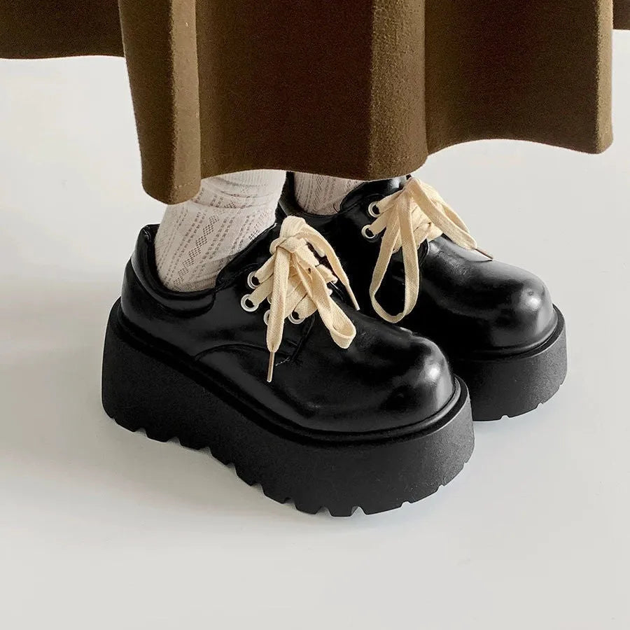 Matte black women's lace-up high-heel shoes with a thick sole and an English muffin heel.