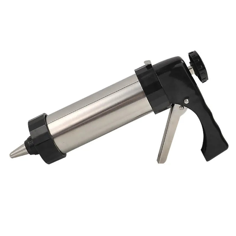 Stainless steel biscuit press machine with assortment of cookie moulds and piping nozzles on a kitchen worktop