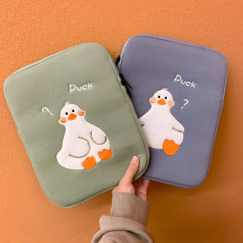 Blue cotton tablet case with embroidered cartoon duck design and a zipper closure.