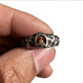 Close-up of a hand-forged copper Buddha ring with a grotto rock texture, shown in size UK 8.
