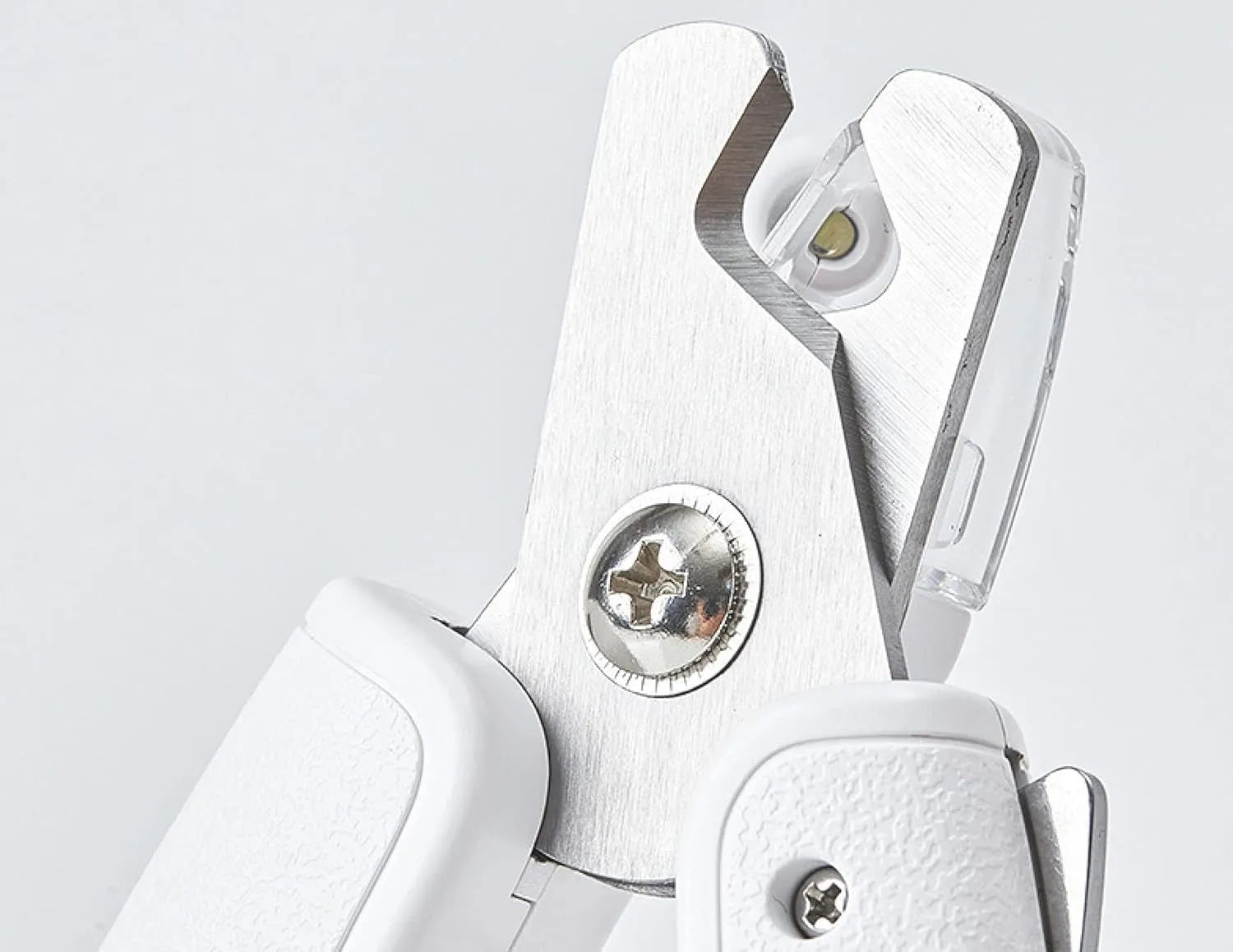 White pet nail clipper with LED light and transparent anti-splash guard on a blue background.