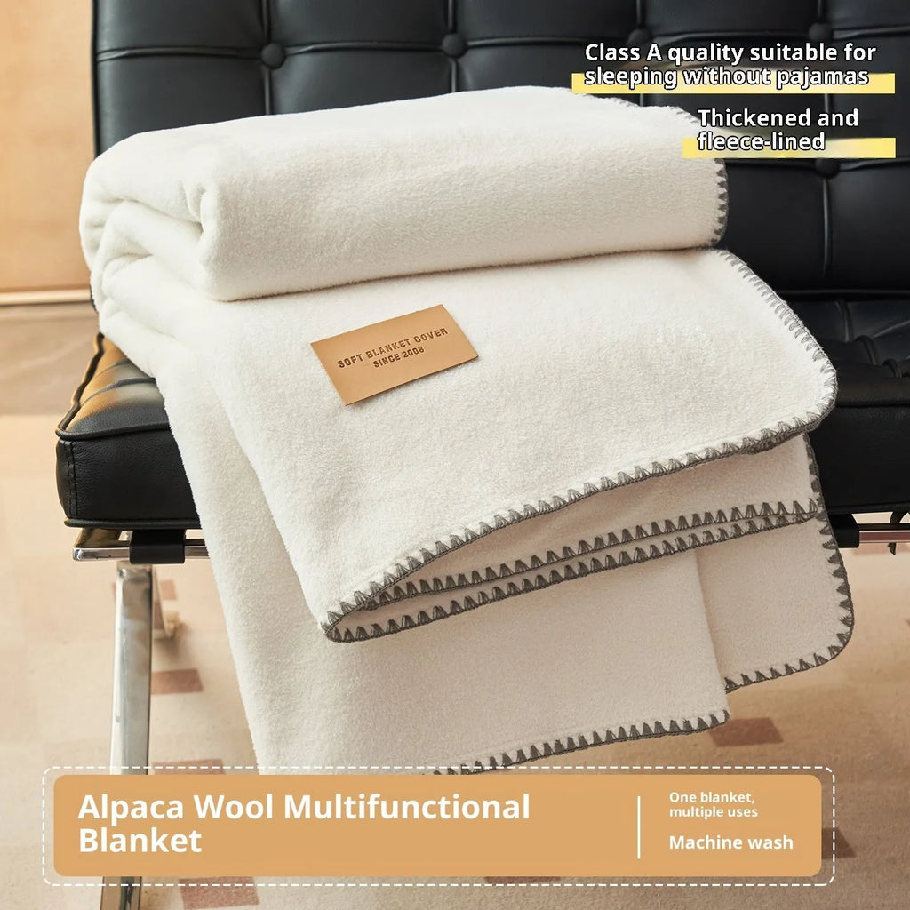 Class A Alpaca Fleecefiber blanket in solid colour, folded on a sofa, showing soft polyester texture