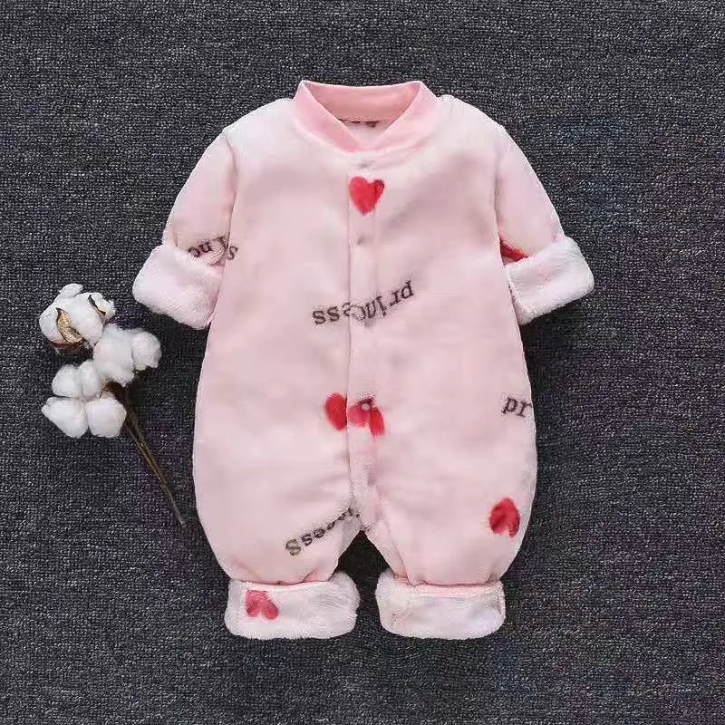 Baby wearing a long-sleeved flannel romper in a pink bunny head print, showcasing the 100% cotton fabric.