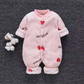 Baby wearing a long-sleeved flannel romper in a pink bunny head print, showcasing the 100% cotton fabric.