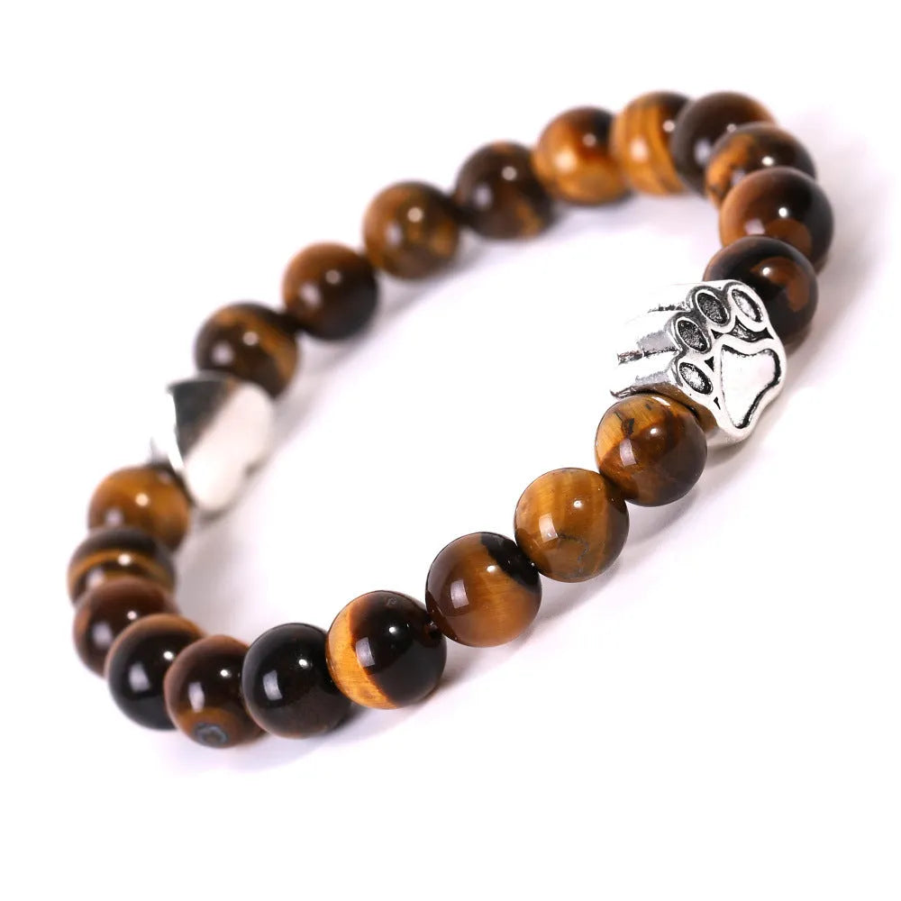 Tigereye and Indian agate stone beaded bracelet with a silver dog's paw charm and a geometric peach heart charm on a white background.