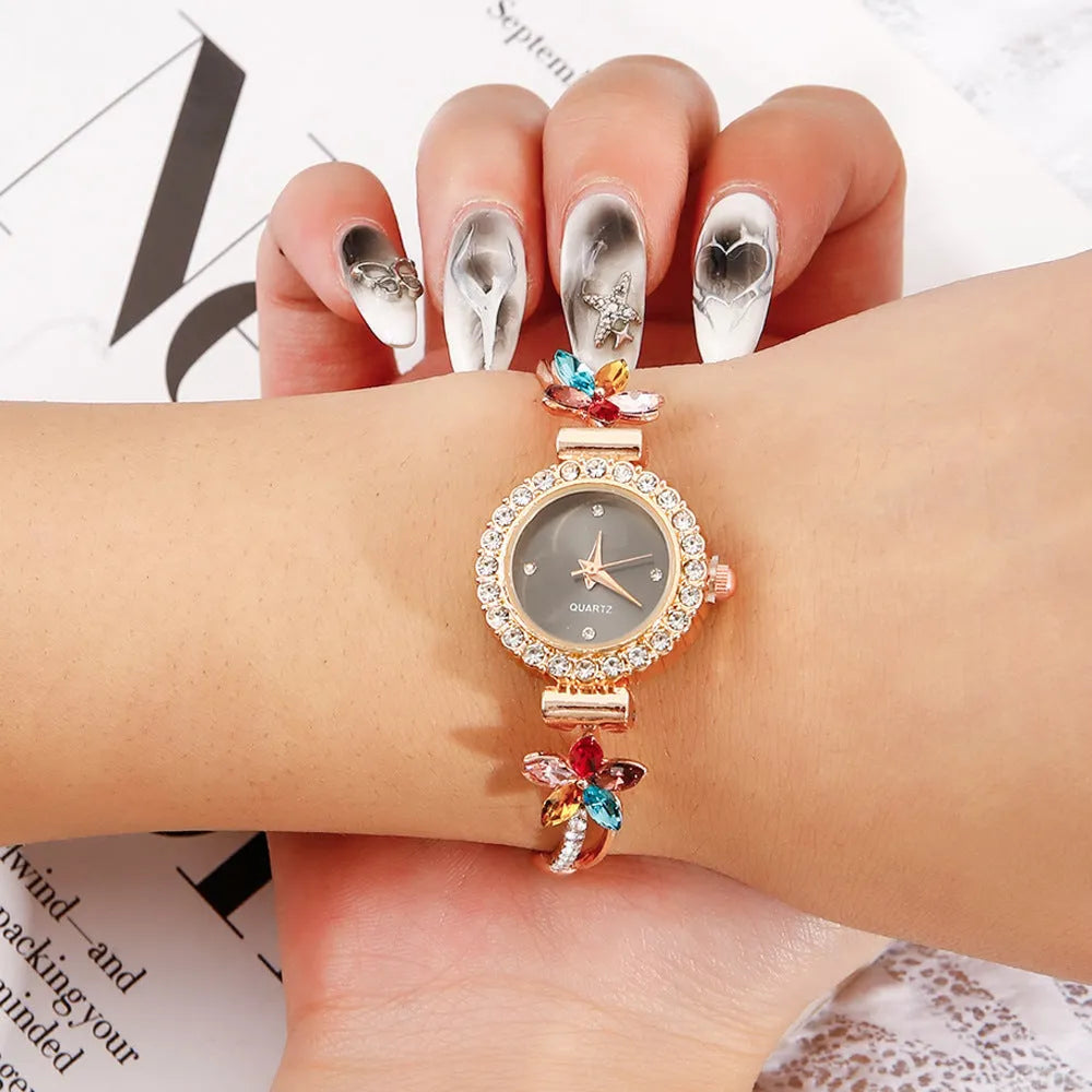 Round women's quartz watch on alloy bracelet with diamond accents and gold finish