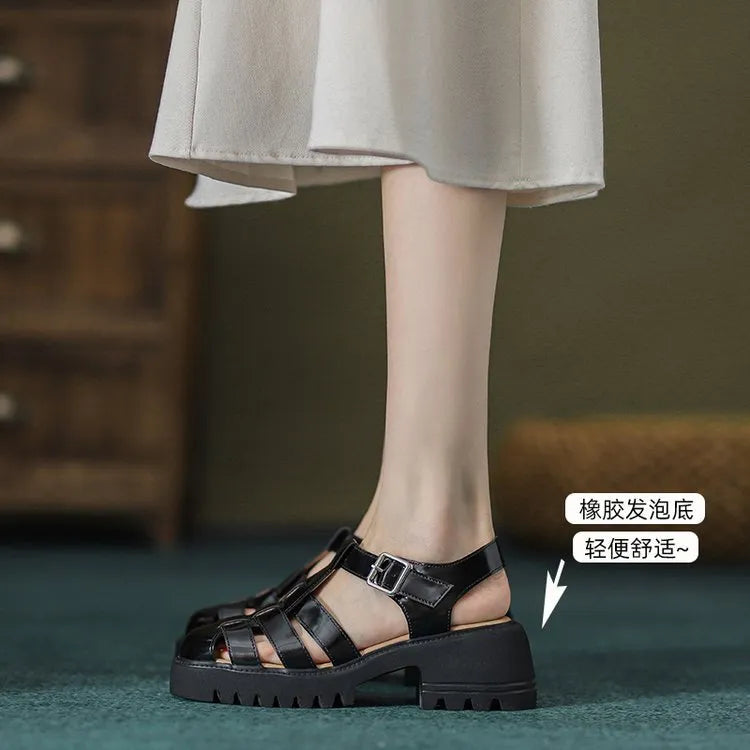 Women's black retro platform sandals with closed toe, chunky rubber sole and buckle fastening
