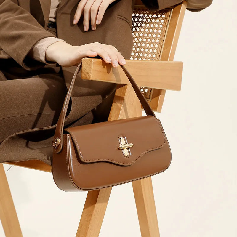 Genuine leather baguette handbag in horizontal square clamshell design, shown in black colour