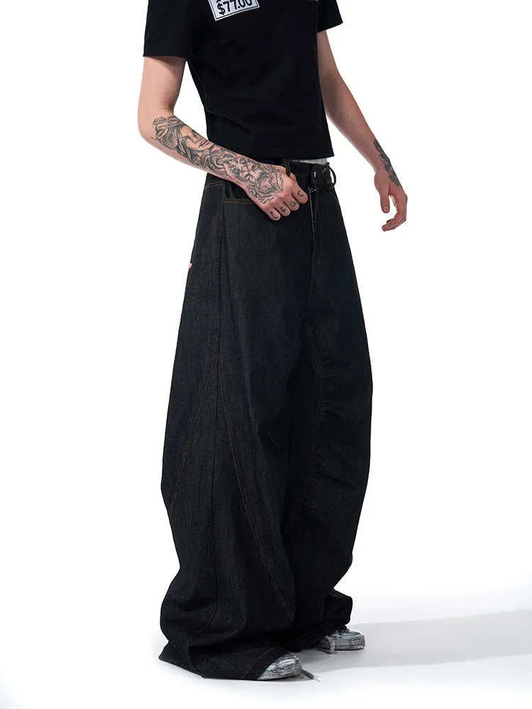 Black wide leg jeans with colour-changing temperature-sensitive embroidery and red ear detailing on a hanger.