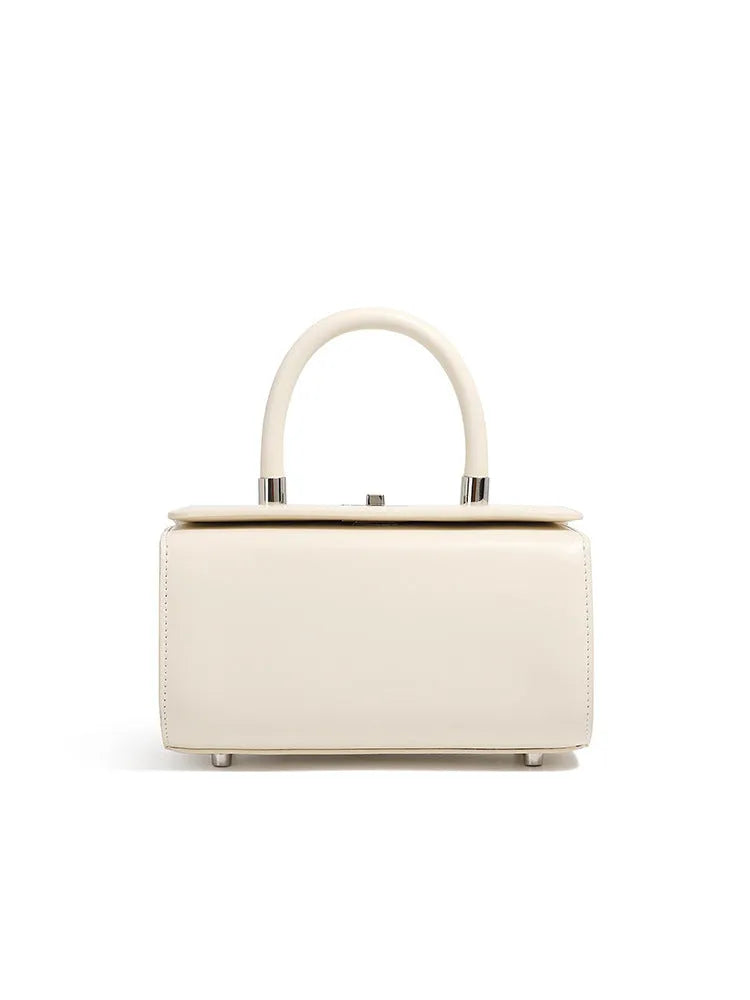 Brown leather women's crossbody bag with a box shape and clamshell opening, shown with interior phone and file pockets.
