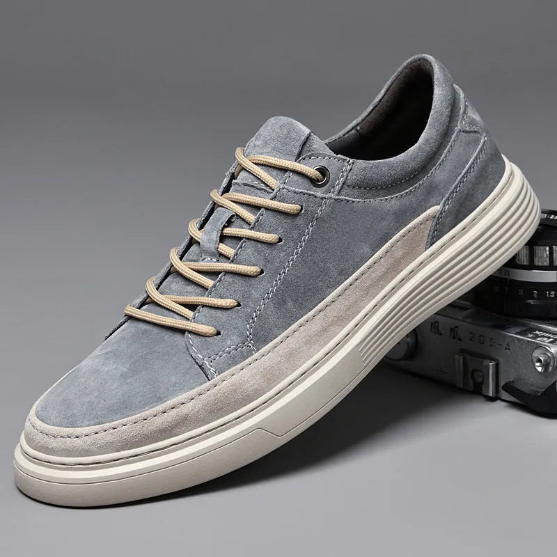 Men's grey pigskin leather casual skate shoes with round toe and flat rubber sole on a light background.