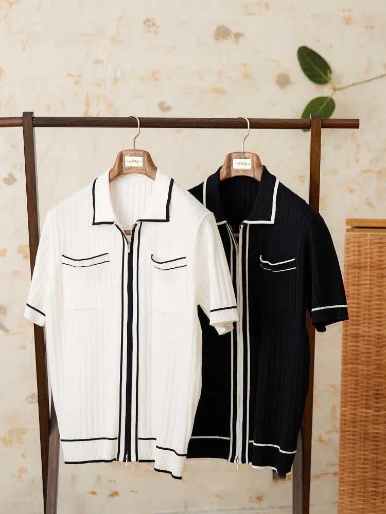Slim fit black knitted polo shirt with a lapel collar and short sleeves on a hanger.