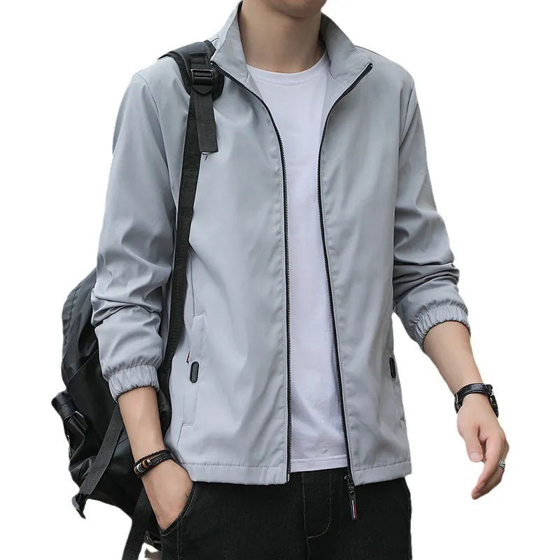 Man wearing a thin, loose lapel Korean-style casual jacket in a neutral colour.