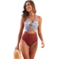 Women's black one-piece swimsuit with a printed patchwork leaf design on the front.