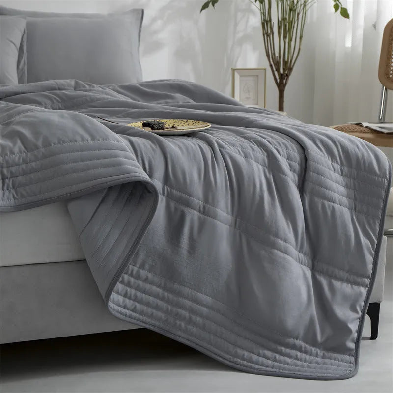 Pure colour seersucker cooling quilt laid flat, showing quilted texture and simple edging.