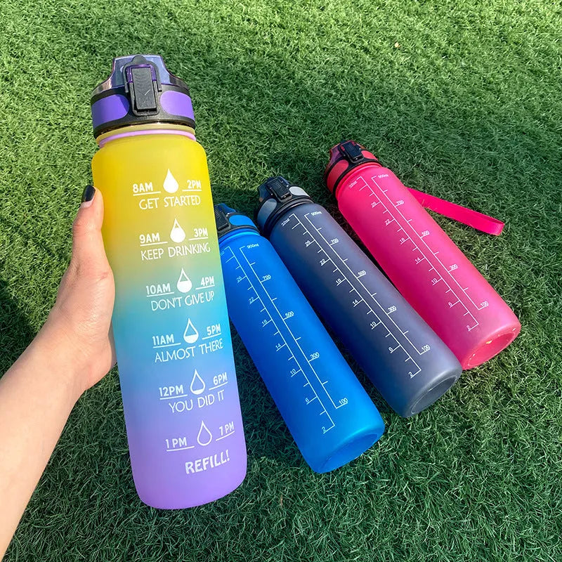 1L Tritan sports water bottle with time markers and flip-top lid in blue-red gradient colour
