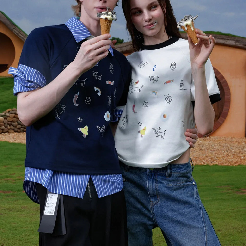 Man wearing a loose fit blue short sleeve shirt with a large cartoon graphic print on the front.