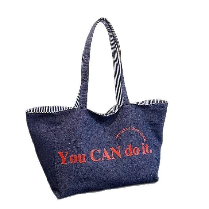 Large canvas tote bag with double straps and mobile phone pocket, 53x35x29cm, available in red, blue, and striped colours.