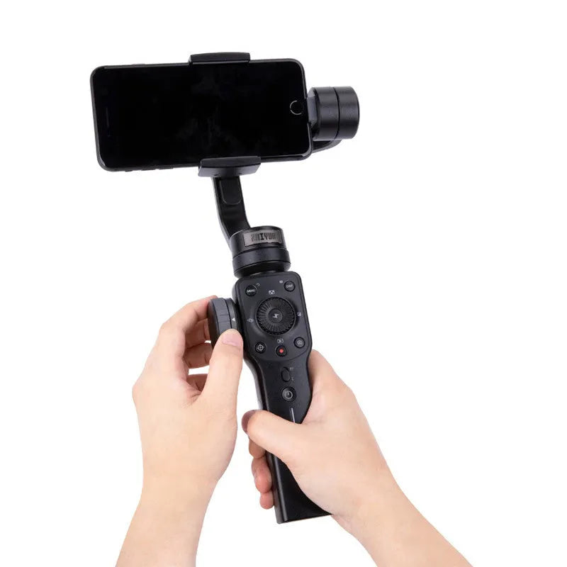 Black handheld mobile phone gimbal stabilizer on a table, made from ABS plastic.