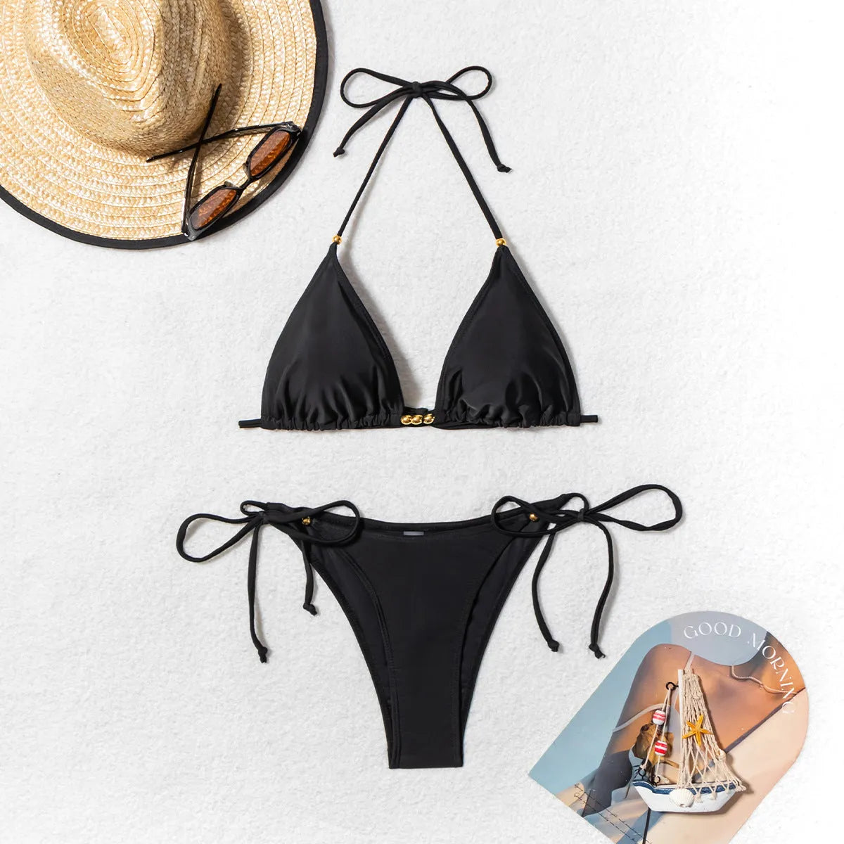 Black women's bikini swimsuit with metal bead detail and split leg design