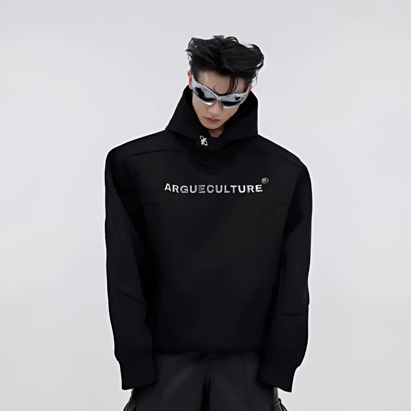 A loose red men's hooded sweater with heavy shoulder pads and metallic silver printing on the front.
