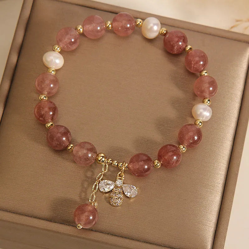Women's bracelet with strawberry quartz beads, freshwater pearls, and zircon crystals on gold-tone clasp
