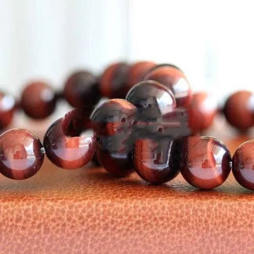 Red tigereye wooden bracelet with geometric bead design showing lightning eye reserva colour stone details