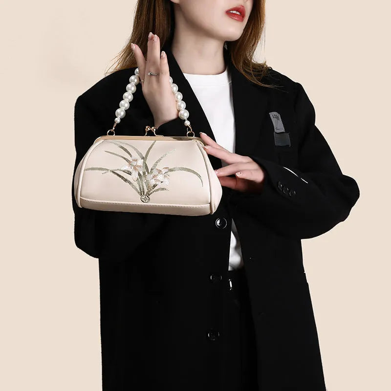 Beige women's embroidered shoulder bag in soft PU leather with shell-shaped design