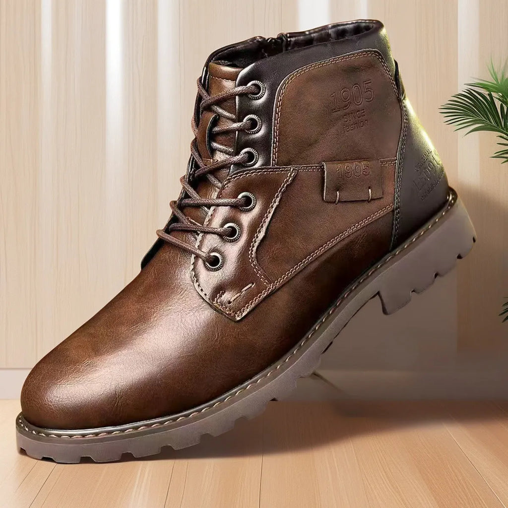 Men's brown leather-look ankle boots with a side zip fastening and rubber sole on a white background.