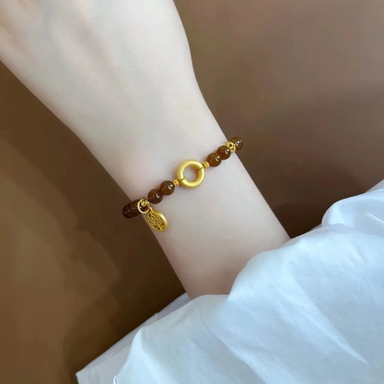 Caramel-coloured women's bracelet with electroplated beeswax finish and lily flower design.