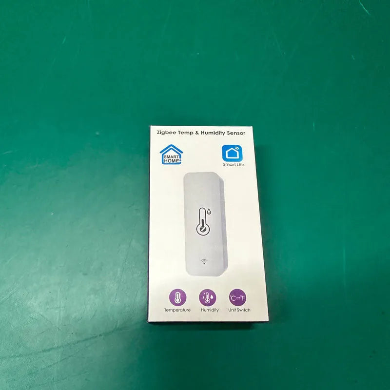 Compact white WiFi temperature and humidity sensor with LCD display for smart home monitoring
