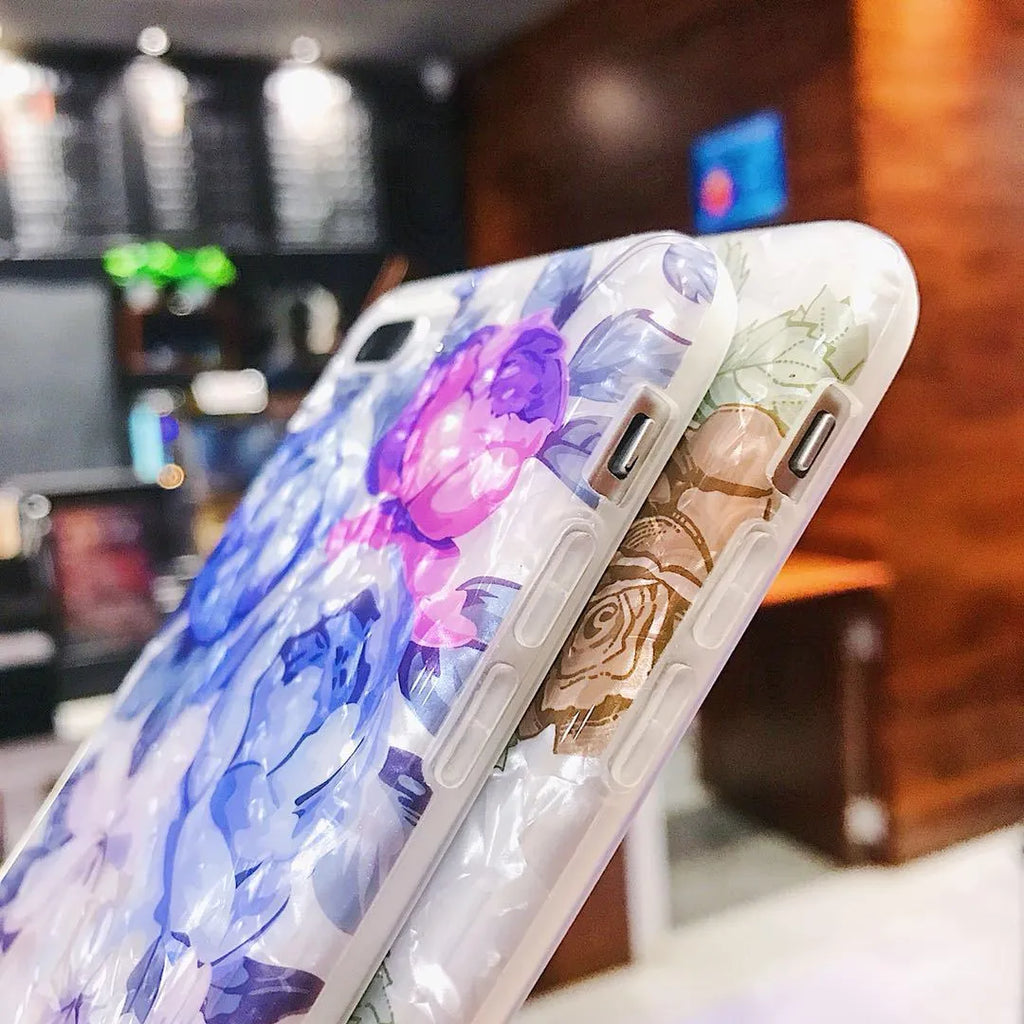 Dream Shell soft TPU iPhone case with rose flower design in purple, shown on a phone.