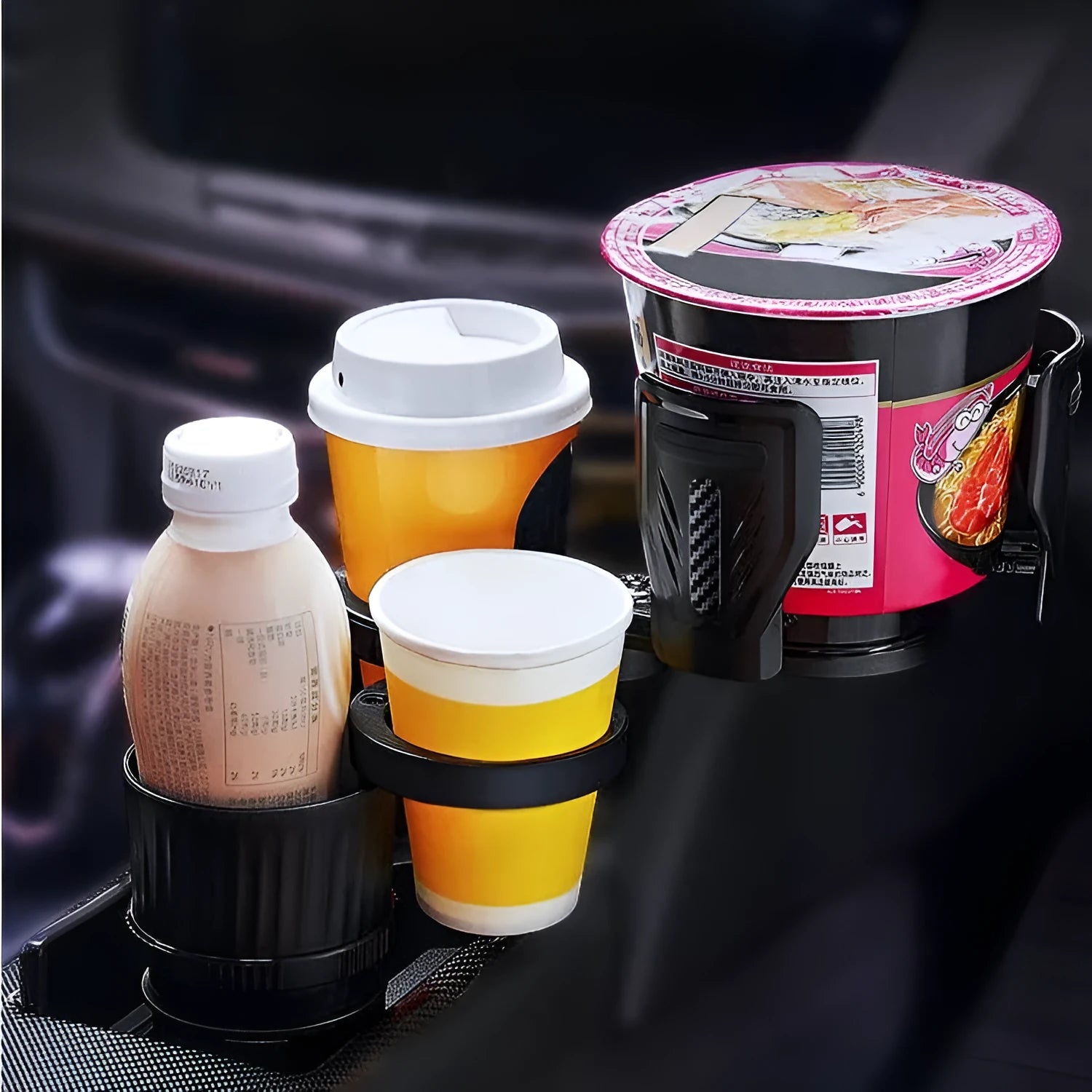 Retractable black car drink cup holder with adjustable base on a car console.