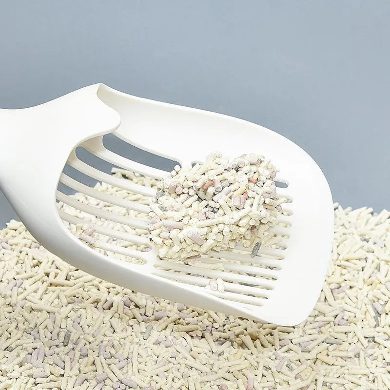White plastic cat litter scoop with a storage base, shown with dimensions 29.5cm by 12.8cm.